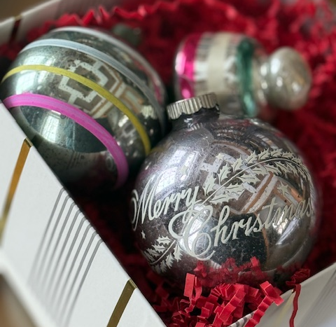 A box of vintage Christmas baubles in an article called Someone really needs to dust this place