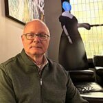 man at Vessel with ghost cutout in the background