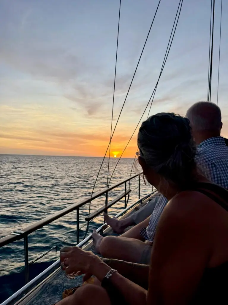 Two people sailing at sunset on the Melissa in Bonaire